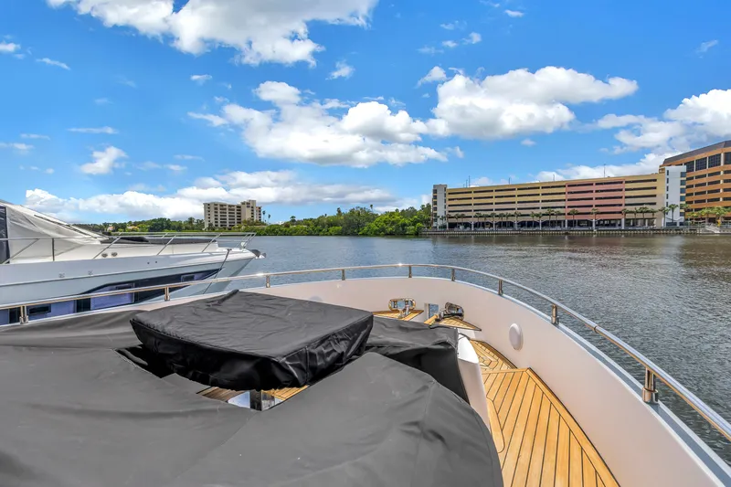 Slide: The Image of Flybridge of 2022 OKEAN 50 yacht docked by waterfront buildings under blue sky. - 98