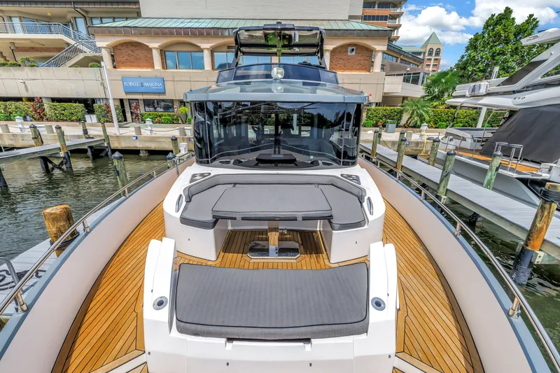 Slide: The Image of 2022 OKEAN 50 Flybridge yacht docked at marina, featuring sleek design and spacious deck. - 53
