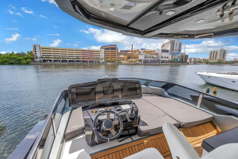 Slide: The Image of Luxurious 2022 OKEAN 50 Flybridge yacht with modern helm, docked in urban waterfront setting. - 71