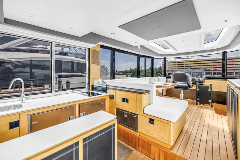 Slide: The Image of Luxurious interior of 2022 OKEAN 50 Flybridge yacht with modern kitchen and seating area. - 27