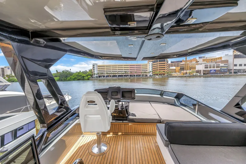 Slide: The Image of Flybridge view of 2022 OKEAN 50 yacht, featuring sleek design and waterfront cityscape. - 67