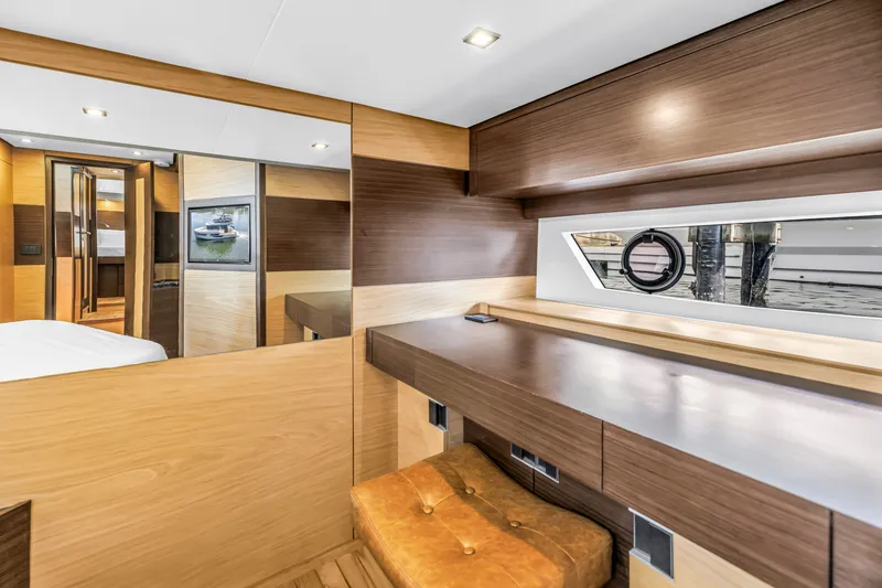 Slide: The Image of Luxurious interior of 2022 OKEAN 50 Flybridge yacht with modern wood finishes and window view. - 39