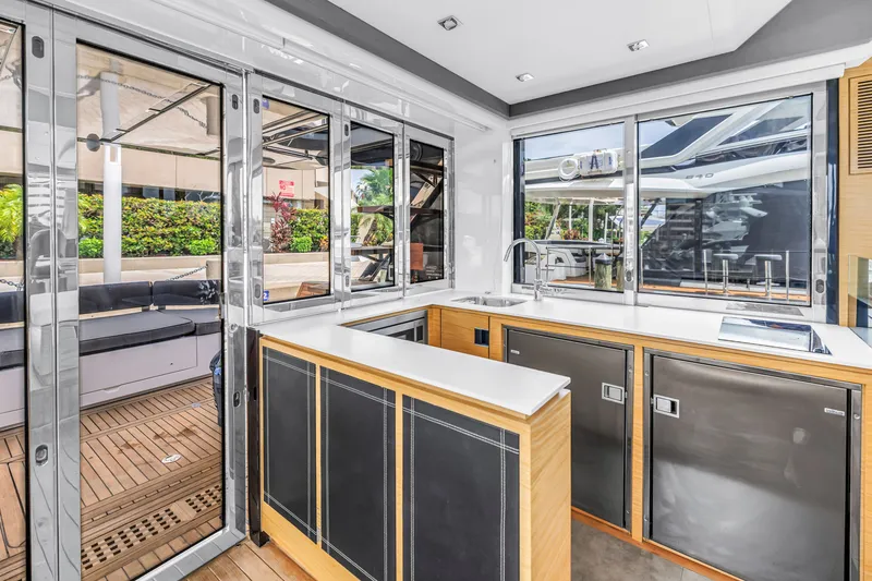 Slide: The Image of Modern kitchen interior on 2022 OKEAN 50 Flybridge yacht, featuring sleek design and ample natural light. - 23