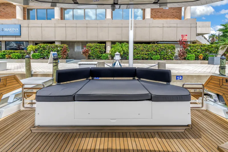 Slide: The Image of Luxury 2022 OKEAN 50 Flybridge yacht with sleek deck seating at marina. - 20