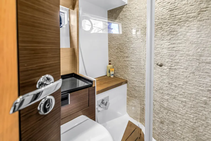 Slide: The Image of Luxurious bathroom in 2022 OKEAN 50 Flybridge yacht with modern fixtures and textured walls. - 49