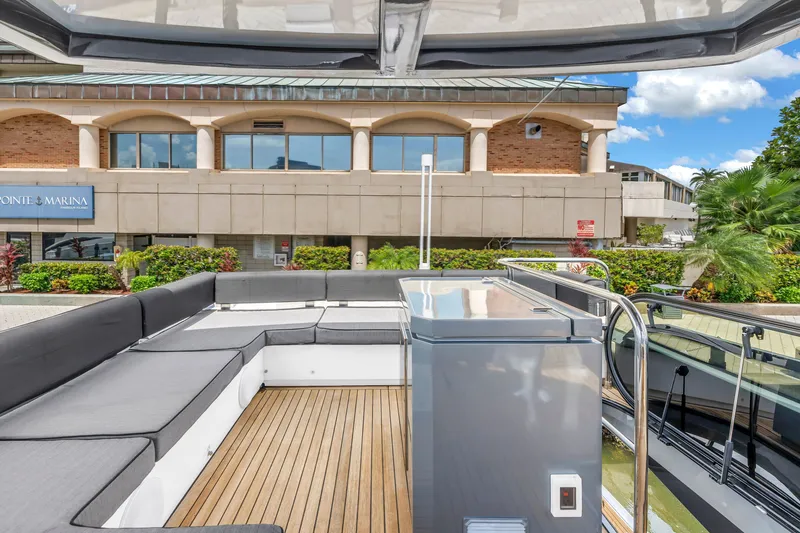 Slide: The Image of Flybridge of 2022 OKEAN 50 yacht with modern seating and marina view. - 64
