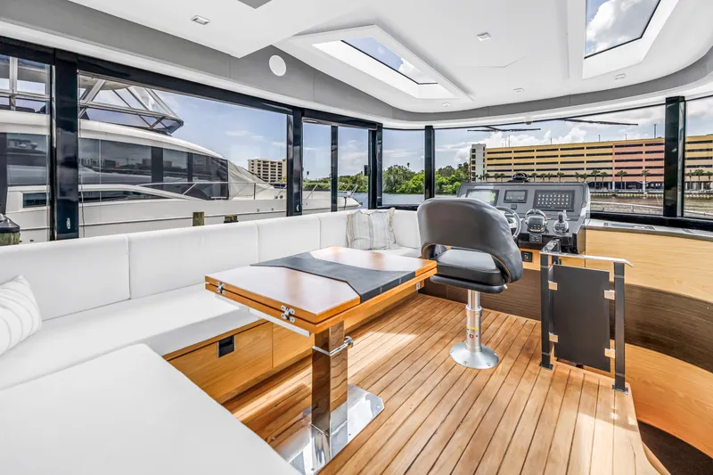 Slide: The Image of Luxurious interior of 2022 OKEAN 50 Flybridge yacht with modern helm and seating area. - 29