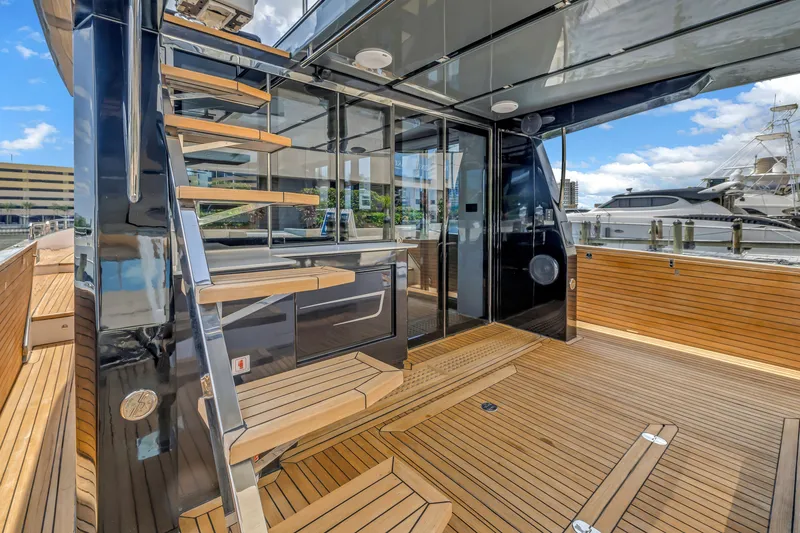 Slide: The Image of Modern 2022 OKEAN 50 Flybridge yacht with sleek wooden deck and stylish staircase. - 77