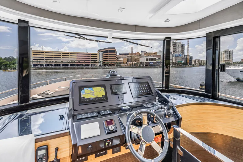 Slide: The Image of Helm of 2022 OKEAN 50 Flybridge yacht with cityscape view through windows. - 31