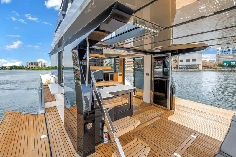 Slide: The Image of Luxurious 2022 OKEAN 50 Flybridge yacht with spacious deck and waterfront view. - 17