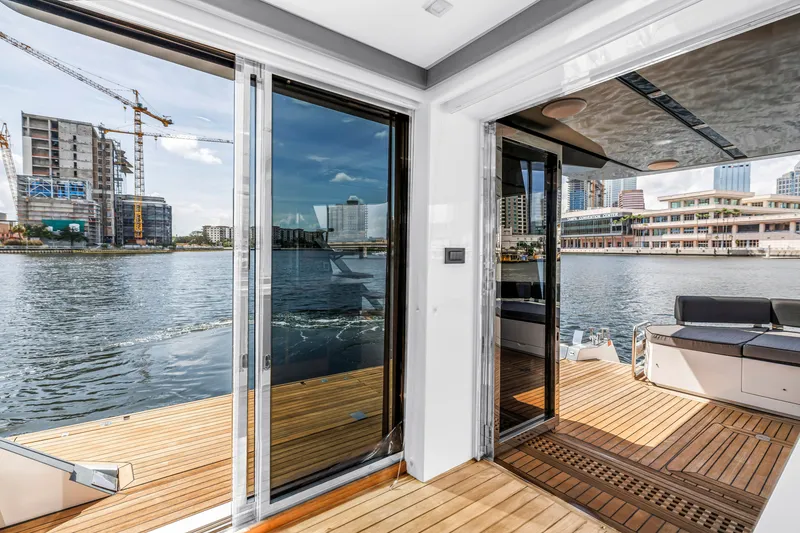 Slide: The Image of Luxurious 2022 OKEAN 50 Flybridge yacht interior with waterfront cityscape view. - 78