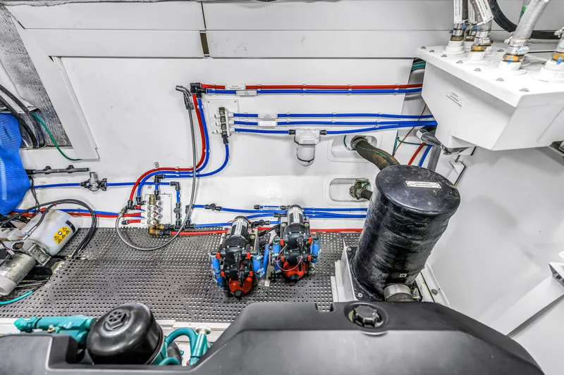 Slide: The Image of Engine room of 2022 OKEAN 50 Flybridge yacht, showcasing intricate piping and machinery. - 102