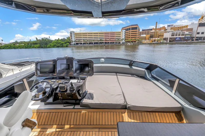 Slide: The Image of Flybridge of 2022 OKEAN 50 yacht with modern controls and waterfront view. - 70