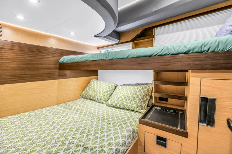 Slide: The Image of Interior of 2022 OKEAN 50 Flybridge yacht with modern bunk beds and wooden cabinetry. - 45
