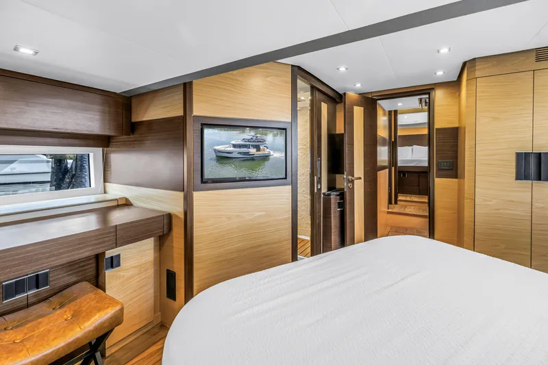 Slide: The Image of Luxurious interior of 2022 OKEAN 50 Flybridge yacht with modern wood finishes and cozy bedroom. - 37