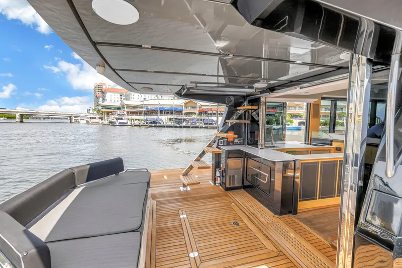 Slide: The Image of Luxurious 2022 OKEAN 50 Flybridge yacht with sleek deck and modern amenities, docked by waterfront. - 14