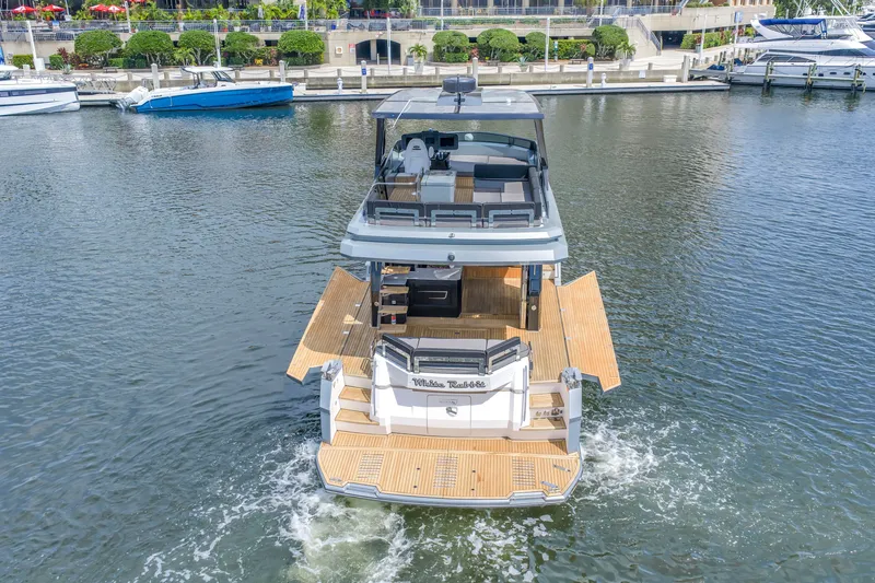 Slide: The Image of 2022 OKEAN 50 Flybridge yacht with open deck design, cruising in a marina. - 10