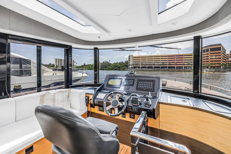 Slide: The Image of Luxurious interior of 2022 OKEAN 50 Flybridge yacht with modern helm and panoramic windows. - 30