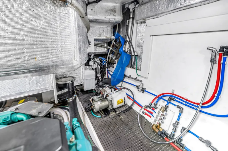 Slide: The Image of Engine room of 2022 OKEAN 50 Flybridge yacht, showcasing mechanical systems and piping. - 106