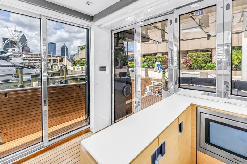 Slide: The Image of Interior view of 2022 OKEAN 50 Flybridge yacht with marina backdrop. - 25
