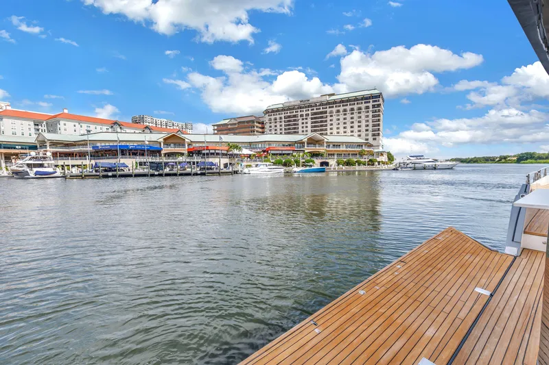Slide: The Image of Modern marina view from 2022 OKEAN 50 Flybridge yacht, featuring waterfront buildings and clear skies. - 81