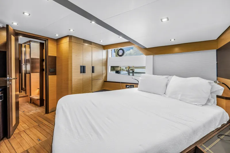 Slide: The Image of Luxurious bedroom interior of 2022 OKEAN 50 Flybridge yacht with modern wood finishes. - 35