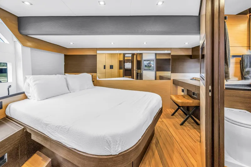 Slide: The Image of Luxurious bedroom interior of 2022 OKEAN 50 Flybridge yacht with modern design and wooden accents. - 34
