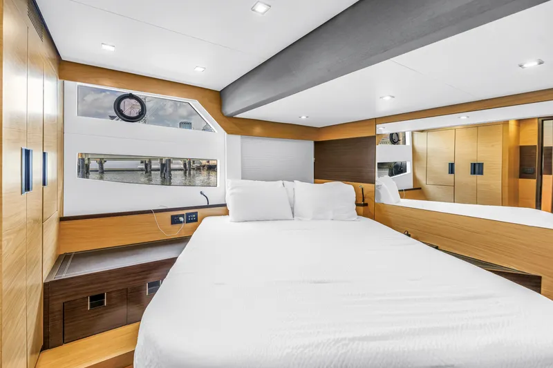 Slide: The Image of Luxurious bedroom interior of 2022 OKEAN 50 Flybridge yacht with modern design and wood accents. - 41