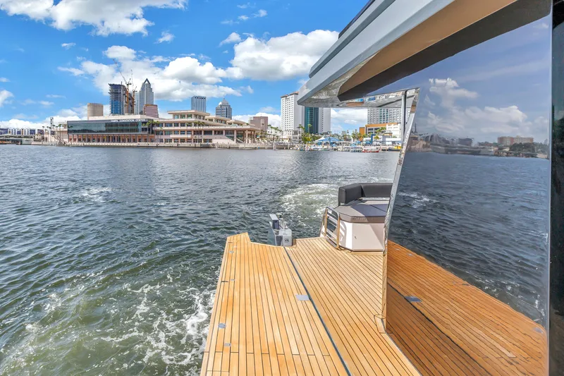 Slide: The Image of 2022 OKEAN 50 Flybridge yacht cruising near city waterfront under blue sky. - 79