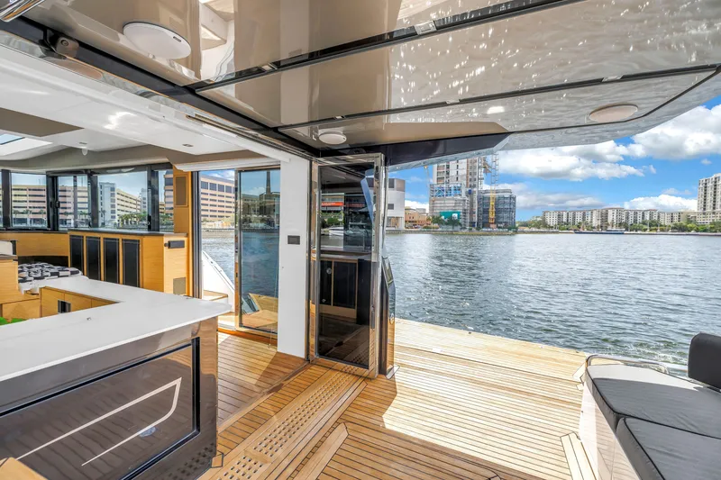 Slide: The Image of Luxurious 2022 OKEAN 50 Flybridge yacht interior with waterfront city view. - 83