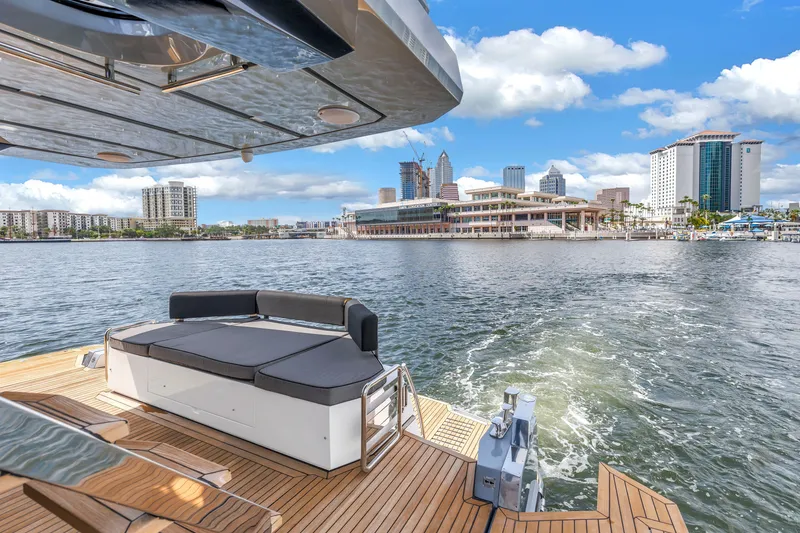 Slide: The Image of 2022 OKEAN 50 Flybridge yacht with city skyline view, featuring luxurious deck seating. - 21