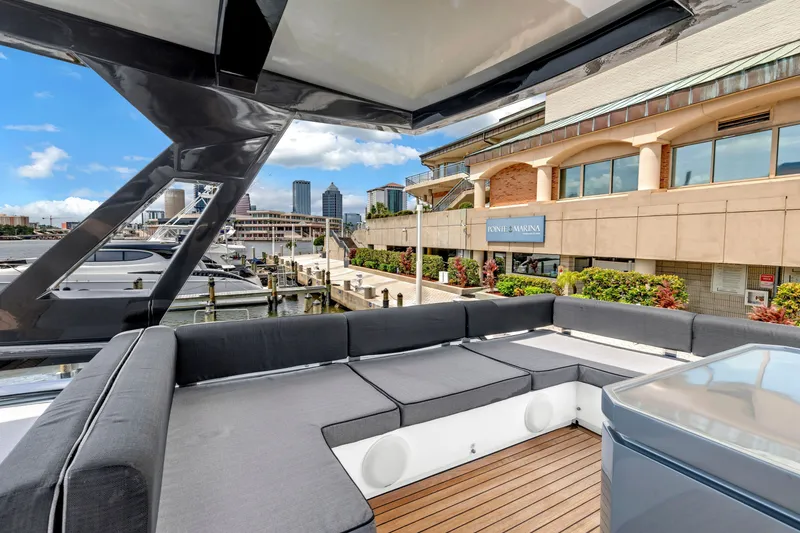 Slide: The Image of Luxurious 2022 OKEAN 50 Flybridge yacht docked at a marina with cityscape views. - 63