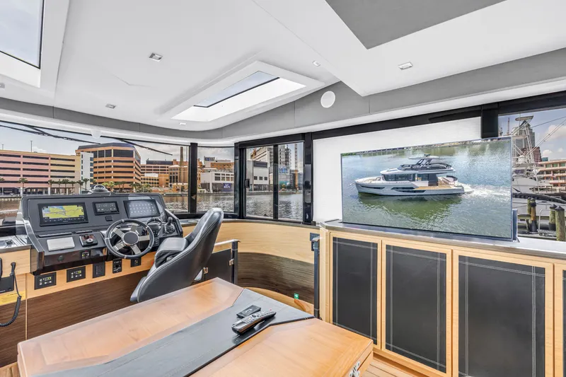 Slide: The Image of Luxurious interior of 2022 OKEAN 50 Flybridge yacht with modern helm and large screen display. - 87