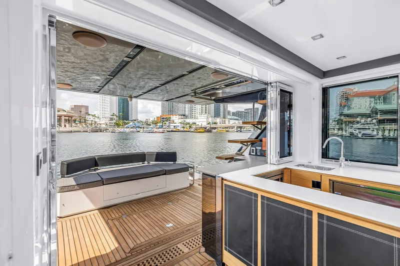 Slide: The Image of Luxurious 2022 OKEAN 50 Flybridge yacht interior with waterfront view and modern amenities. - 22