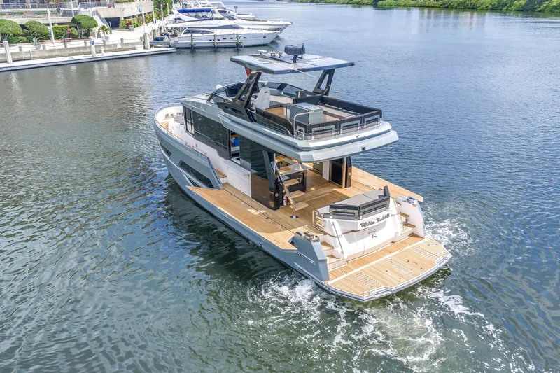 Slide: The Image of 2022 OKEAN 50 Flybridge yacht cruising on a serene waterway. - 7