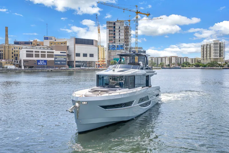 Slide: The Image of Luxury 2022 OKEAN 50 Flybridge yacht cruising in urban waterfront setting. - 8
