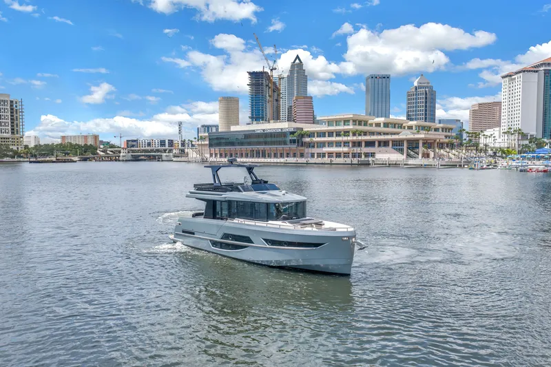 Slide: The Image of 2022 OKEAN 50 Flybridge yacht cruising in urban waterfront setting. - 9