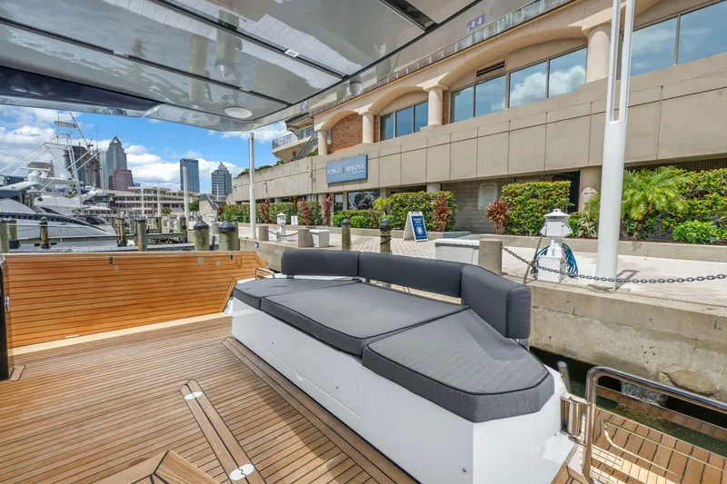 Slide: The Image of Luxury OKEAN 50 Flybridge yacht docked, showcasing sleek design and spacious deck, 2022 model. - 76