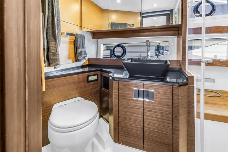 Slide: The Image of Luxurious bathroom in 2022 OKEAN 50 Flybridge yacht with modern fixtures and wood accents. - 46