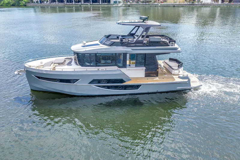 Slide: The Image of 2022 OKEAN 50 Flybridge yacht cruising on calm waters. - 6