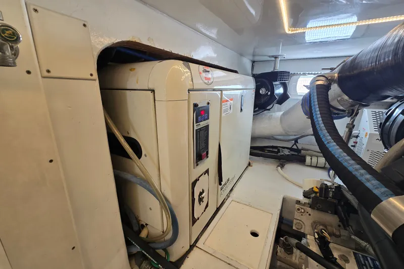 Slide: The Image of Engine room of a 2006 Jersey Cape 44 Convertible yacht, showcasing machinery and equipment. - 46