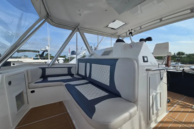 Slide: The Image of 2006 Jersey Cape 44 Convertible yacht interior with cushioned seating and helm station. - 27