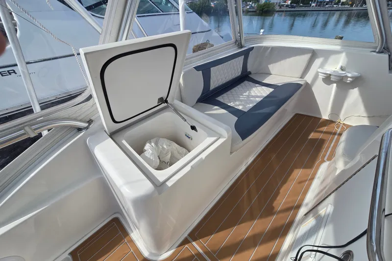 Slide: The Image of 2006 Jersey Cape 44 Convertible boat interior with seating and storage compartment. - 28