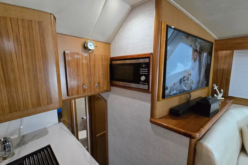 Slide: The Image of Interior of 2006 Jersey Cape 44 Convertible yacht with wood cabinetry and modern amenities. - 13