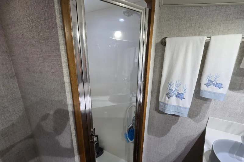 Slide: The Image of Bathroom interior of 2006 Jersey Cape 44 Convertible yacht with shower and decorative towels. - 20
