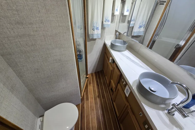 Slide: The Image of Luxurious bathroom in 2006 Jersey Cape 44 Convertible yacht with modern fixtures and wooden flooring. - 19