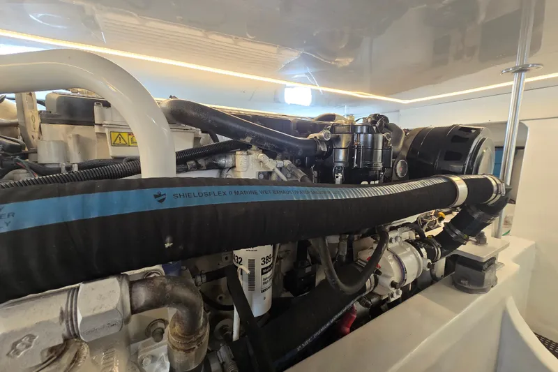 Slide: The Image of Engine room of a 2006 Jersey Cape 44 Convertible boat, showcasing detailed components. - 45