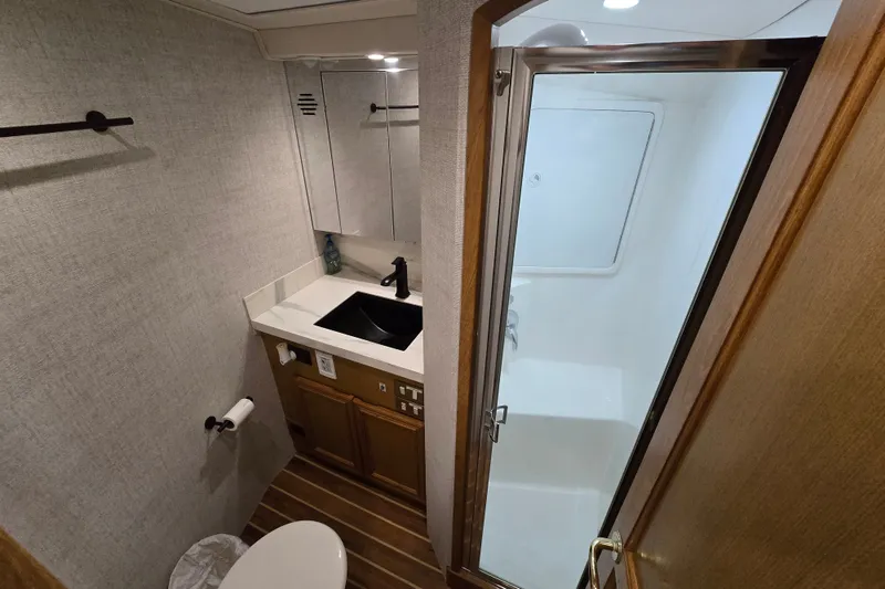 Slide: The Image of Bathroom interior of 2006 Jersey Cape 44 Convertible yacht, featuring sink and shower. - 23
