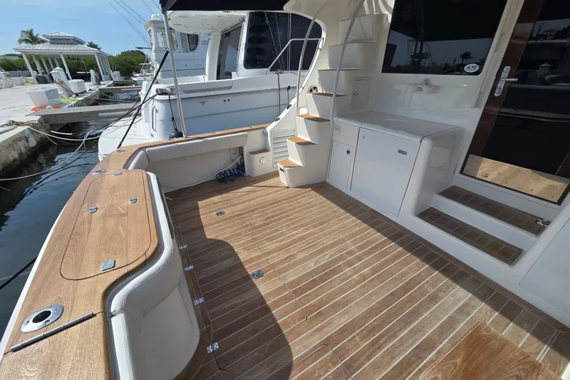 Slide: The Image of 2006 Jersey Cape 44 Convertible yacht with teak deck and sleek white interior. - 39