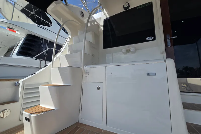 Slide: The Image of Staircase and deck area of 2006 Jersey Cape 44 Convertible yacht. - 35